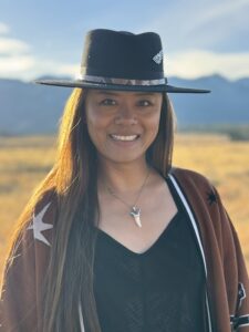 Lana with a charismatic smile, set against a minimalist background, ideal for professional modeling portfolios.